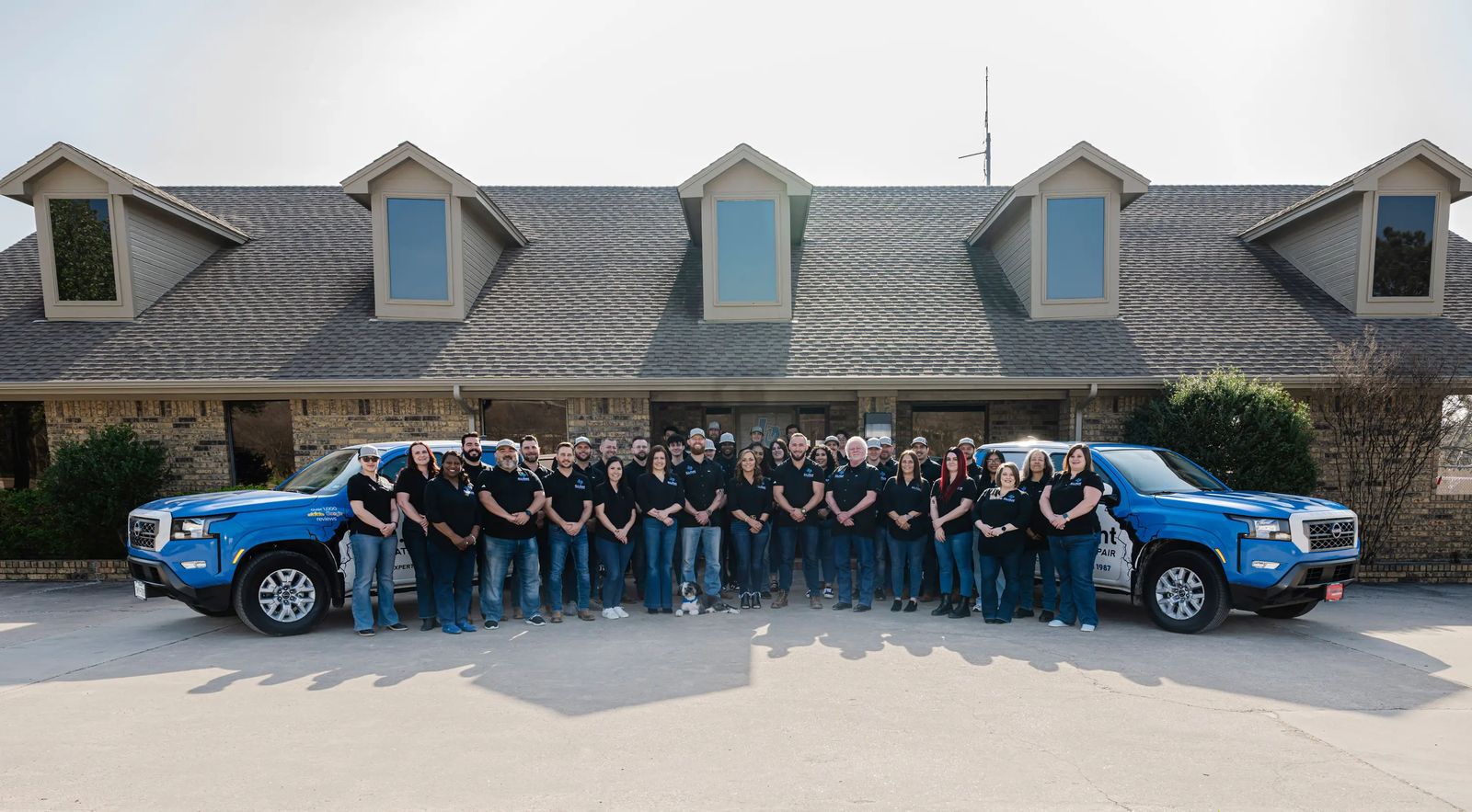 The G.L. Hunt team in front of the office with two company trucks
